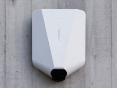 White Easee charger mounted on concrete wall